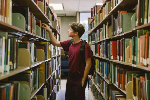 Student in library stacks